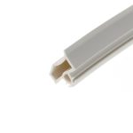 Close-up of a white plastic component with grey inner channels angled across the image.