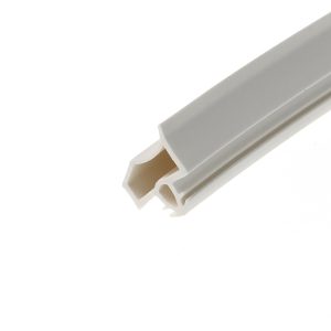 Close-up of a white plastic component with grey inner channels angled across the image.