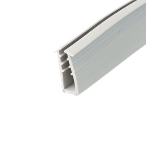 Close-up of a gray plastic extrusion with rectangular grooves running along its length, diagonal angle.