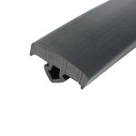 Close-up of a dark gray plastic extrusion with rounded edge and parallel grooves.