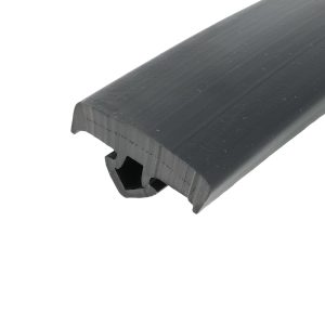 Close-up of a dark gray plastic extrusion with rounded edge and parallel grooves.