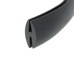 Close-up of a black curved plastic part with a slot and triangular notch.