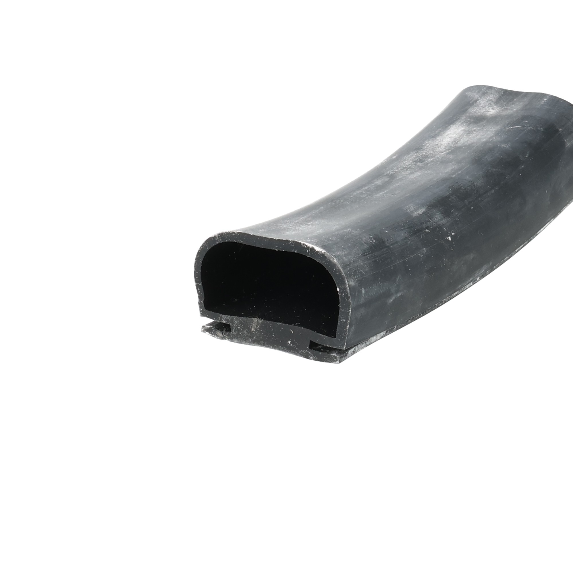 uszczelka-do-drzwi-chlodni-typu-omega-wsuwana-23-x-34mm-silikonowa-czarna-09913-3 - Centrum uszczelek Close-up of a curved black rubber extrusion with a hollow rectangular opening, showing a worn dusty surface.