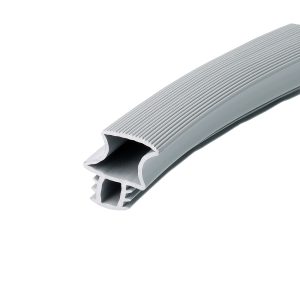 Close-up of a light-gray ribbed plastic extrusion with a hollow curved channel, viewed diagonally.