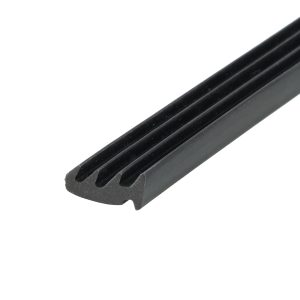 Close-up of a black, grooved plastic rail running diagonally across the frame.