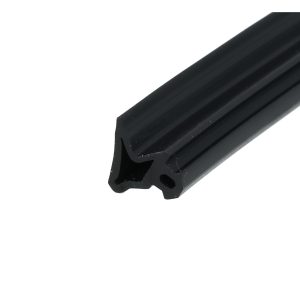 Close-up of a black anodized aluminum extrusion with parallel ridges and a rounded end, photographed at an angle.