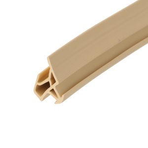 Close-up of a beige plastic extrusion with a hollow hexagonal cross-section, angled diagonally across the frame.