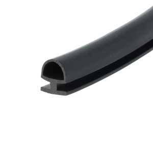 Close-up of a black hollow rounded tube or channel with a curved cross-section, photographed at an angle.