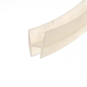 Abstract close-up of pale beige masking tape diagonally across a white background, showing layered edges and soft shadows from the folds.