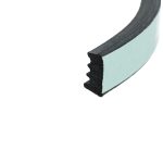 Close-up of a light blue foam sanding block edge with a black abrasive strip showing the foam core.