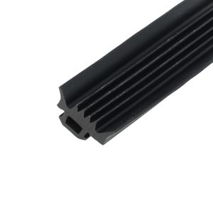 Close-up of a black, ribbed cylindrical object with parallel grooves, set diagonally against a white background.