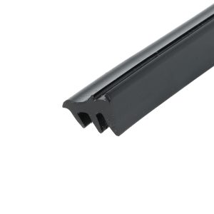 Close-up of a black handgun magazine diagonally across the frame, showing the feed lips at the top against a white background.
