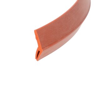 Close-up of an orange curved plastic edge against a white background, showing the tool's smooth surface and a flat edge at the bottom-left.