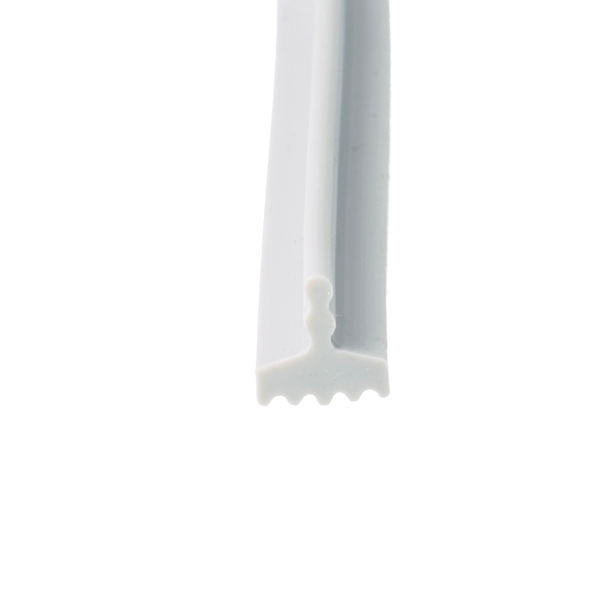 uszczelka-silikonowa-typ-t-2x9x9mm-szara-0995525-3 - Centrum uszczelek Close-up of a white plastic tool with a serrated bottom edge viewed from the side.