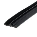 Close-up of a black plastic sliding rail with a ribbed, U-shaped cross-section, angled across the frame.