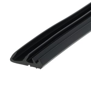 Close-up of a black plastic sliding rail with a ribbed, U-shaped cross-section, angled across the frame.