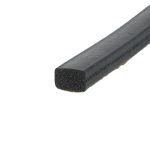 Close-up of a black foam rectangular bar with a porous interior and rough surface texture, seen at an angle.