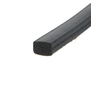 Close-up of a black foam rectangular bar with a porous interior and rough surface texture, seen at an angle.